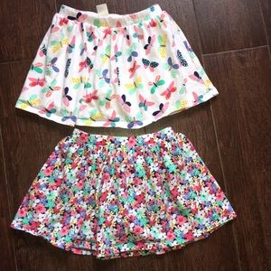 Two Carter’s skirts with shorts under